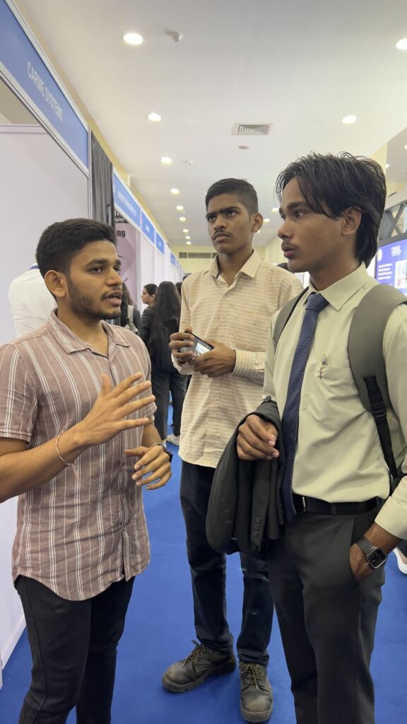 Smit Lakhani Full Stack Developer speaking to one student & I standing in the middle